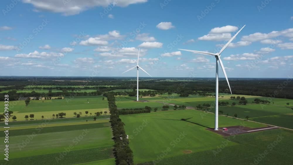 Wind turbines in grassland nature landscape with blue sky captured from above, aerial drone view Wind turbines in grassland nature landscape with blue sky captured from above, aerial drone view