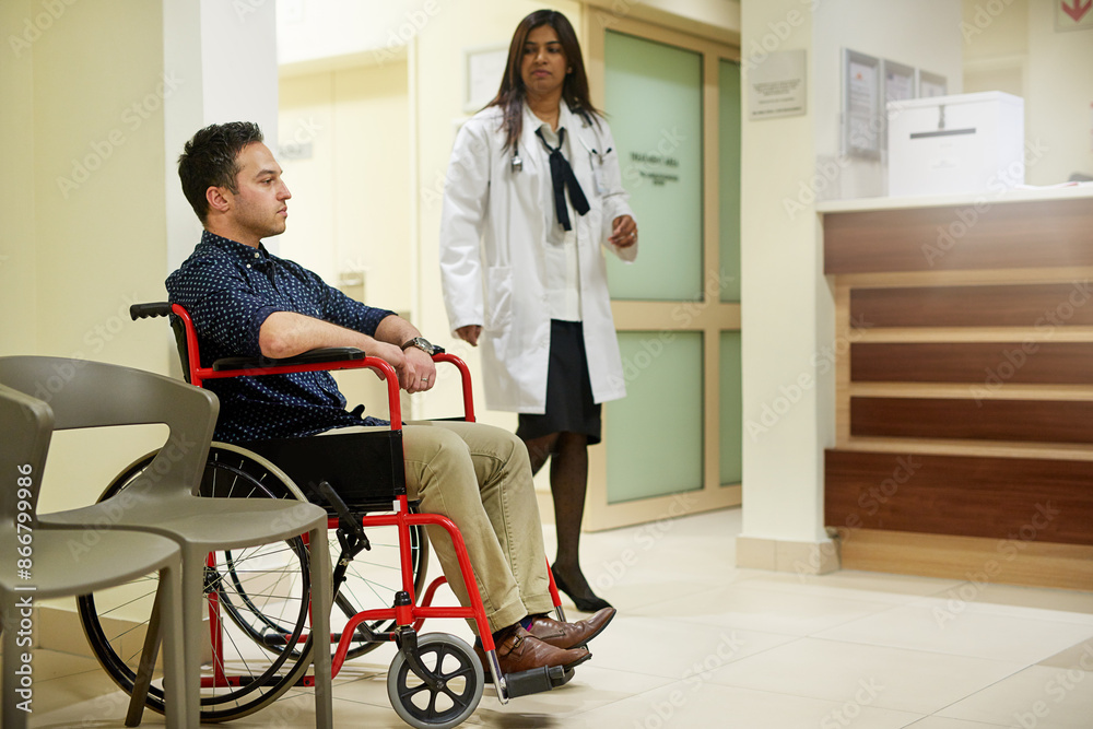 Hospital, female doctor and patient in wheelchair at reception for medical consultation or checkup. Woman, man and person with a disability in healthcare for help with injury examination and support Hospital, female doctor and patient in wheelchair at reception for medical consultation or checkup. Woman, man and person with a disability in healthcare for help with injury examination and support