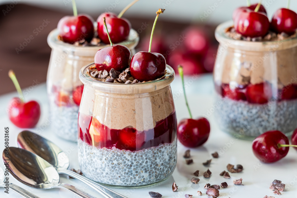 Black forest chia puddings topped with fresh cherries and cacao nibs. Black forest chia puddings topped with fresh cherries and cacao nibs.
