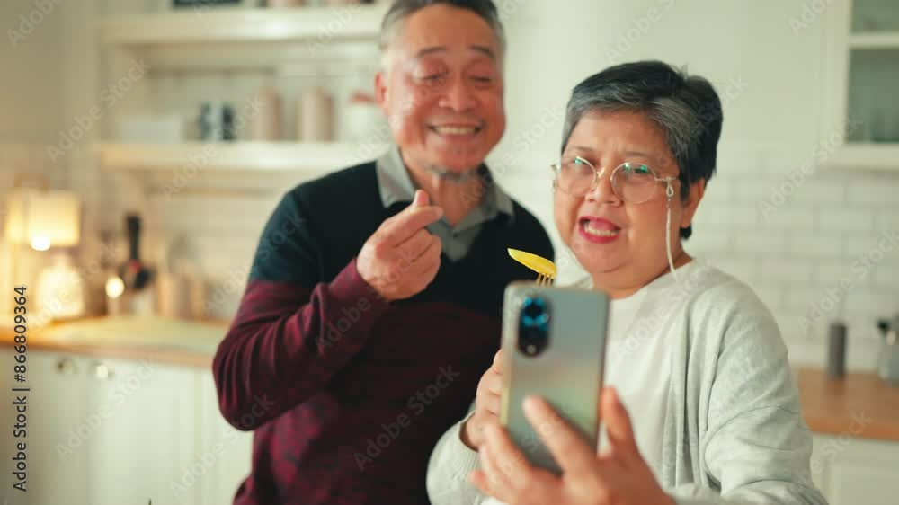senior lifestyle with technology Asian retired couple active senior couple videocall using smartphone at kitchen counter with their family members dauther who study abroad family concept senior lifestyle with technology Asian retired couple active senior couple videocall using smartphone at kitchen counter with their family members dauther who study abroad family concept