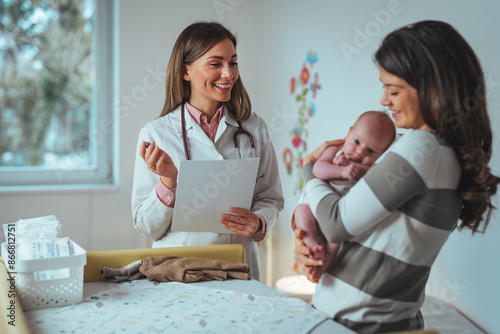 Schilderij op canvas A smiling Caucasian female pediatrician attends to an infant in a bright hospital room, with a mother holding the baby, emphasizing expert pediatric healthcare