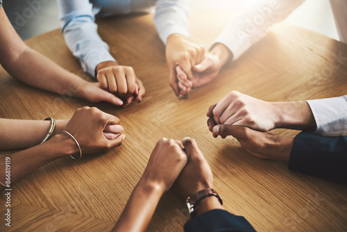 Praying, holding hands and group with religion, table and belief in God, Christian and faith in holy spirit. Support, solidarity or together to worship, praise and trust in Christ or people in church