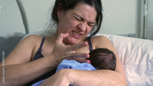 Older sibling leaning against the hospital bed, observing mother wincing in pain, highlighting the challenges and raw emotions of early motherhood in a hospital setting photo