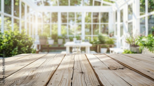 Empty wooden table in greenhouse. Rustic wooden table top for product placement with a blurred background of a bright and airy greenhouse, perfect for spring and summer product displays.