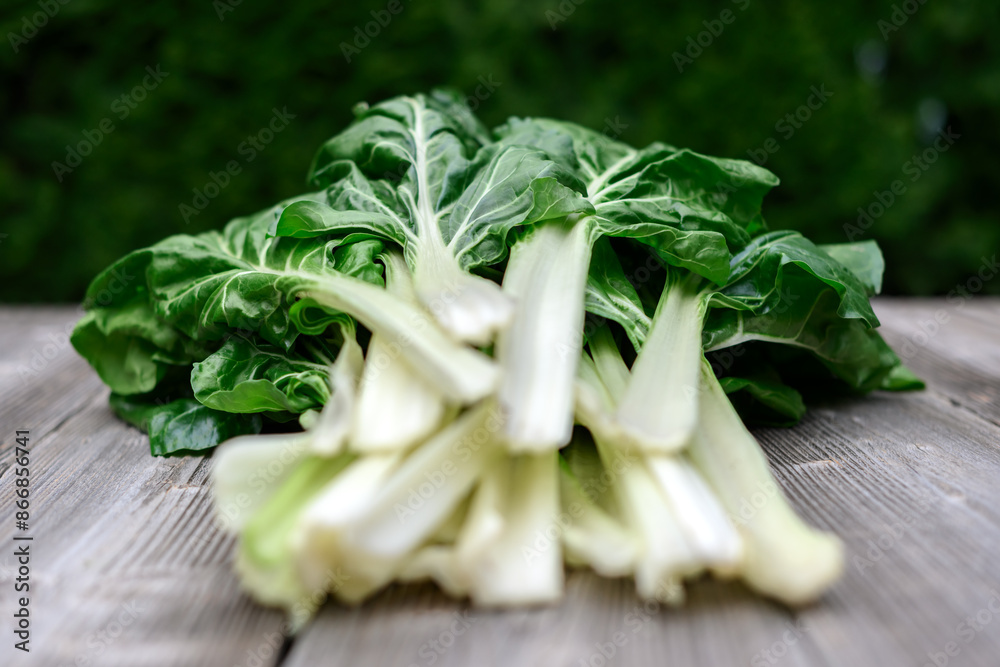 Bunch of organic chard with leaves on a rustic wooden table close up. Food photography Bunch of organic chard with leaves on a rustic wooden table close up. Food photography