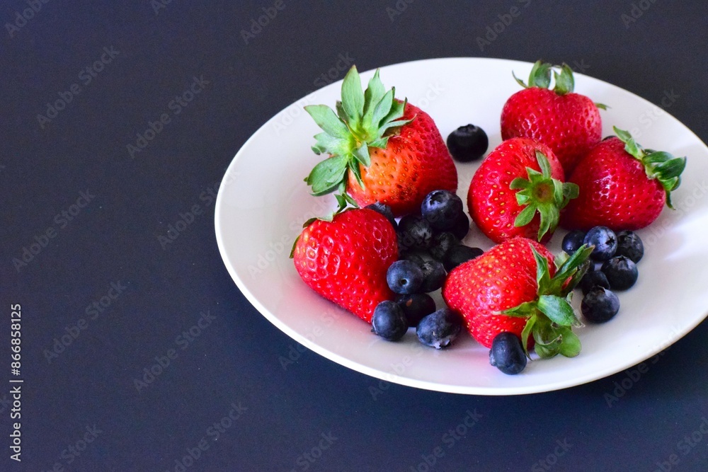 Fresh organic berries on the plate. Fresh strawberry. Fresh blueberry. Diet food. Fresh organic berries on the plate. Fresh strawberry. Fresh blueberry. Diet food.