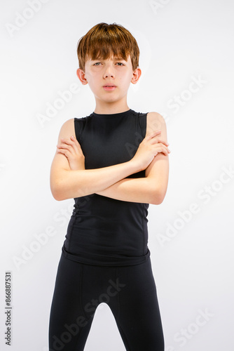 Quadro em tela Young teen boy track runner in black running tights standing with arms crossed,