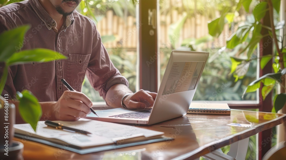 business owner designing a website for their startup, with a laptop and sketchbook on a desk business owner designing a website for their startup, with a laptop and sketchbook on a desk