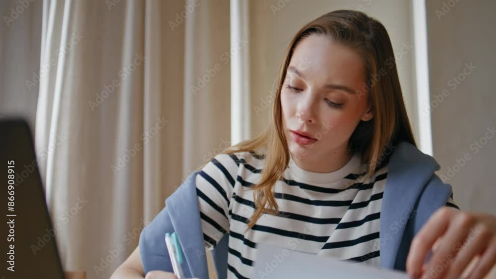 Smart student doing homework at apartment table closeup. Woman writing report Smart student doing homework at apartment table closeup. Woman writing report