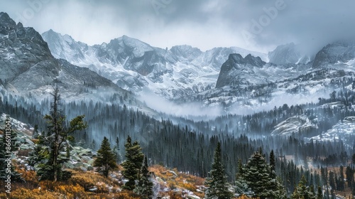 Snow covered Rocky Mountains shrouded in thick fog on a rainy day