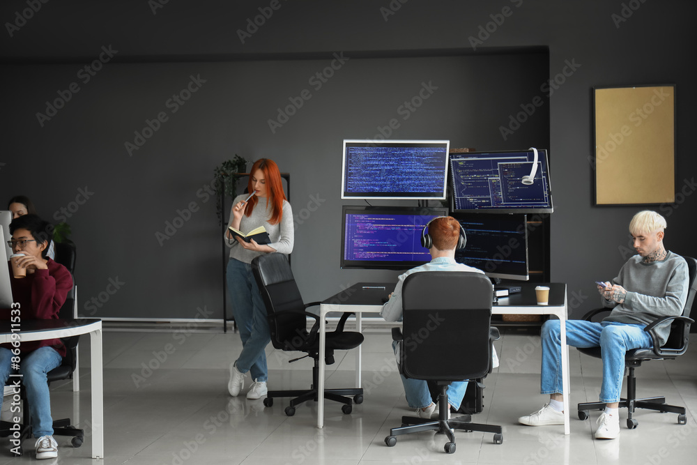 Team of young programmers working in office Team of young programmers working in office