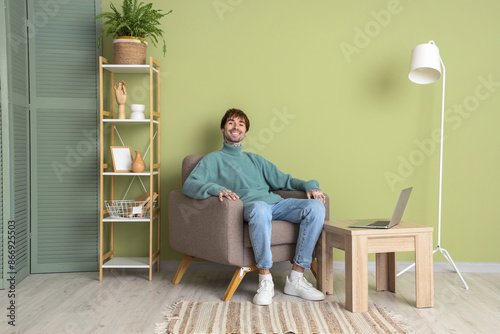 Handsome man resting in sof...