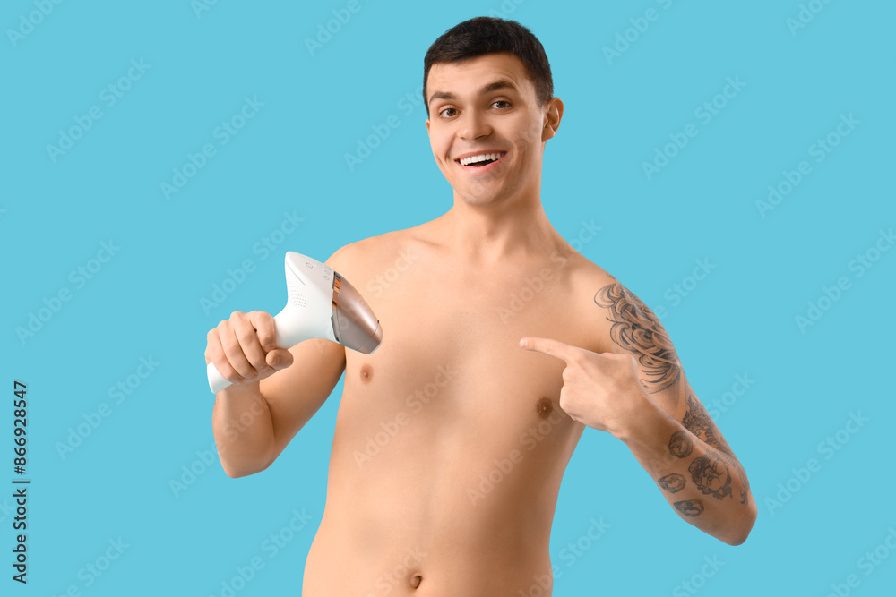 Fototapeta premium Young man with photoepilator on blue background