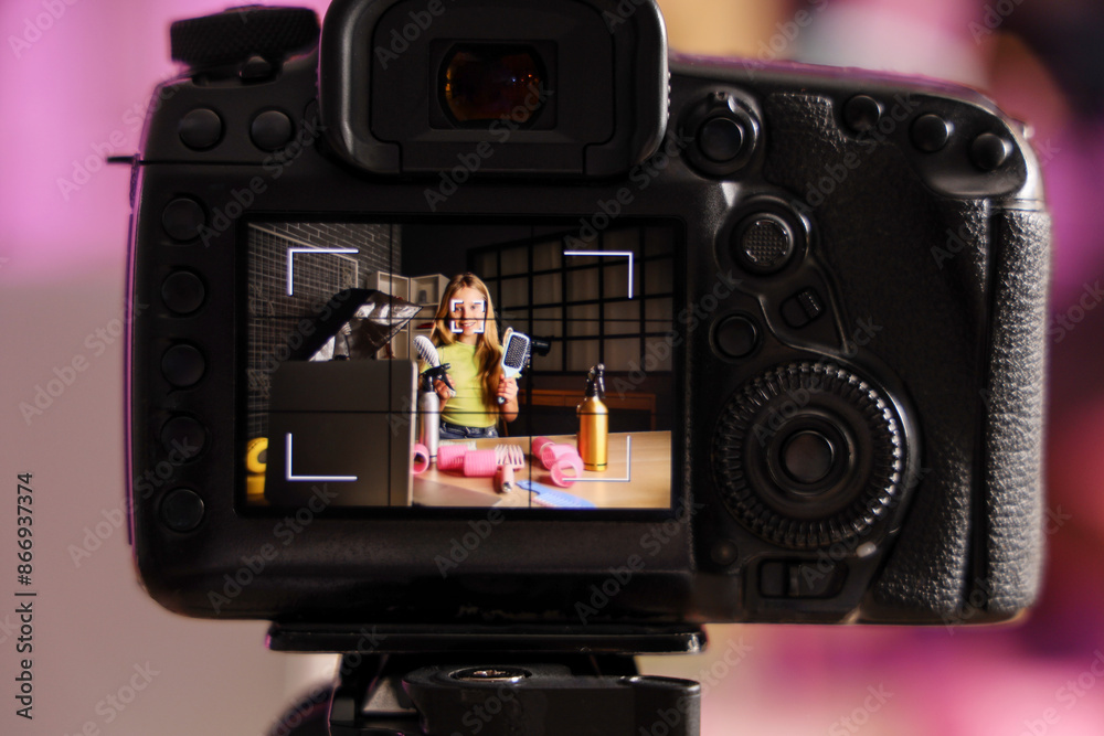 Teenage beauty blogger with hair brushes and recording video at home Teenage beauty blogger with hair brushes and recording video at home