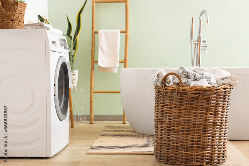 Wicker laundry basket in bathroom interior Wicker laundry basket in bathroom interior