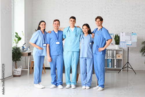 Group of young doctors hugg...