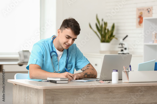 Young male doctor working a...
