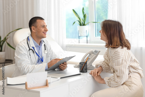 Handsome doctor working wit...