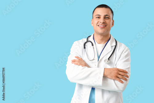 Handsome doctor on blue bac...