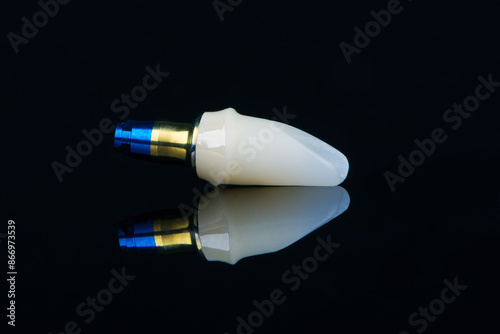 Individual abutment bonded to titanium fabric blue and yellow abutment on black background