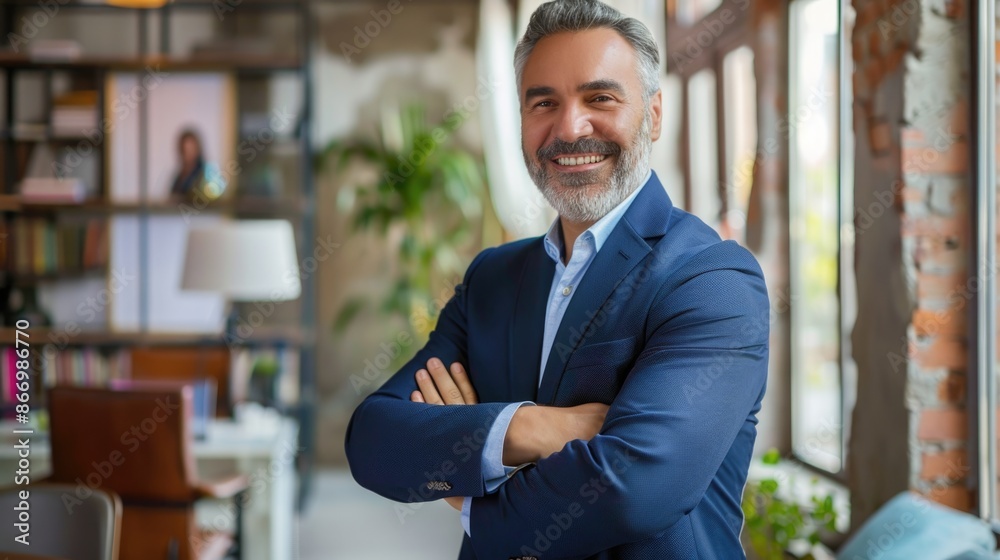 Happy middle aged business man ceo standing in office arms crossed. Smiling mature confident professional executive manager, proud lawyer, businessman leader wearing blue suit Happy middle aged business man ceo standing in office arms crossed. Smiling mature confident professional executive manager, proud lawyer, businessman leader wearing blue suit