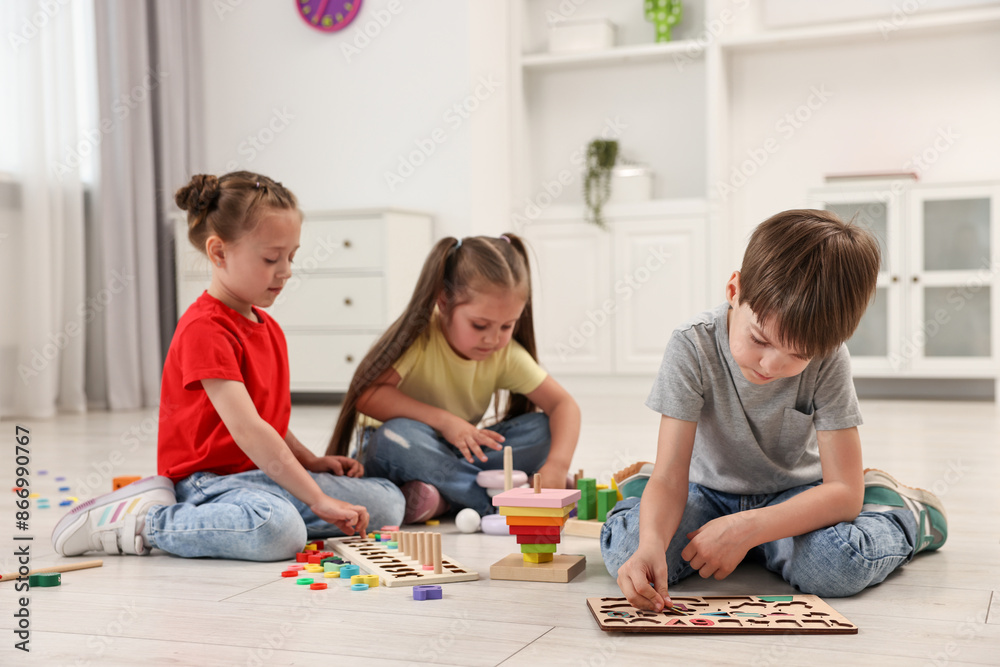 Naklejka premium Cute little children playing together on floor indoors