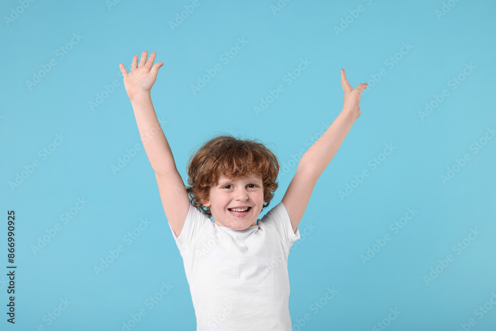 Portrait of cute little boy on light blue background Portrait of cute little boy on light blue background