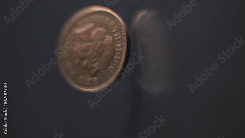 One Penny coin rotating slow motion, 0,01 £, vertical view