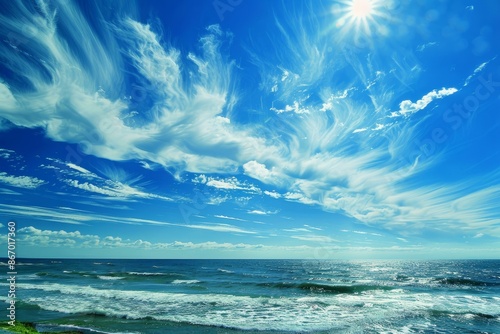 Beautiful seascape with cirrus clouds covering the blue sky over the ocean on a sunny day