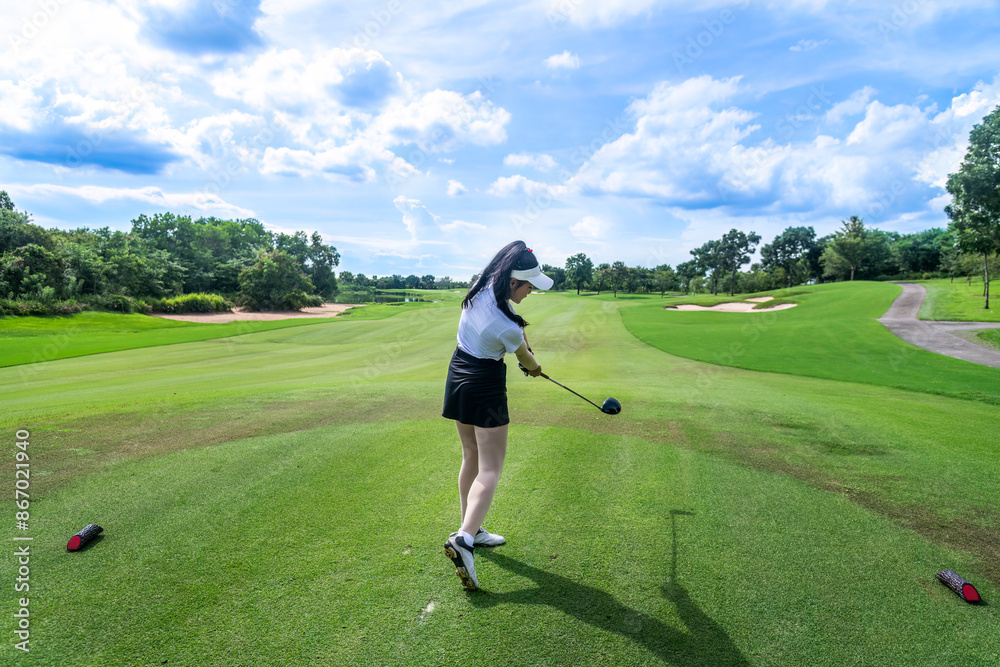 Professional woman golfer teeing golf in golf tournament competition at golf course for winner Professional woman golfer teeing golf in golf tournament competition at golf course for winner