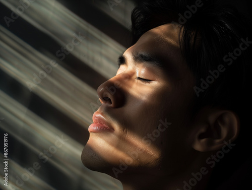 close up portrait of asian man basking in the soft sunlight