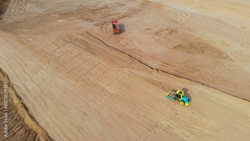 Heavy machinery on construction site demonstrating construction of infrastructure. Excavators and dump trucks work efficiently, ensuring fast construction of infrastructure and preparing site.