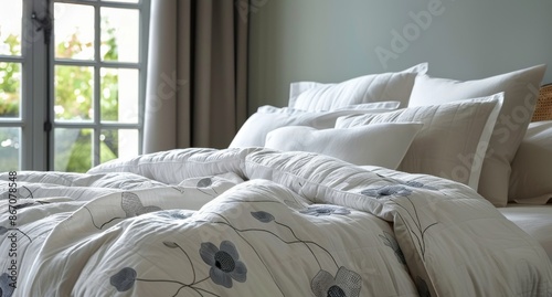 White Bed With Embroidered Floral Design Near Window