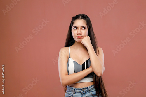 A Woman Is Thinking And Have Her Hand On Her Chin While Standing