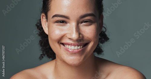 Woman, face and skincare or smile in studio, happy and acne treatment for dermatology wellness. Glowing, clean and routine transformation, background and confident for natural breakout prevention photo