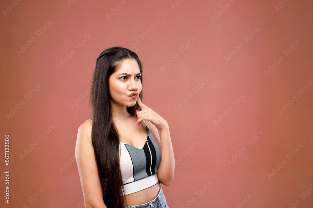A Charming Girl Is Making A Pout While Thinking And Looking Away A Charming Girl Is Making A Pout While Thinking And Looking Away