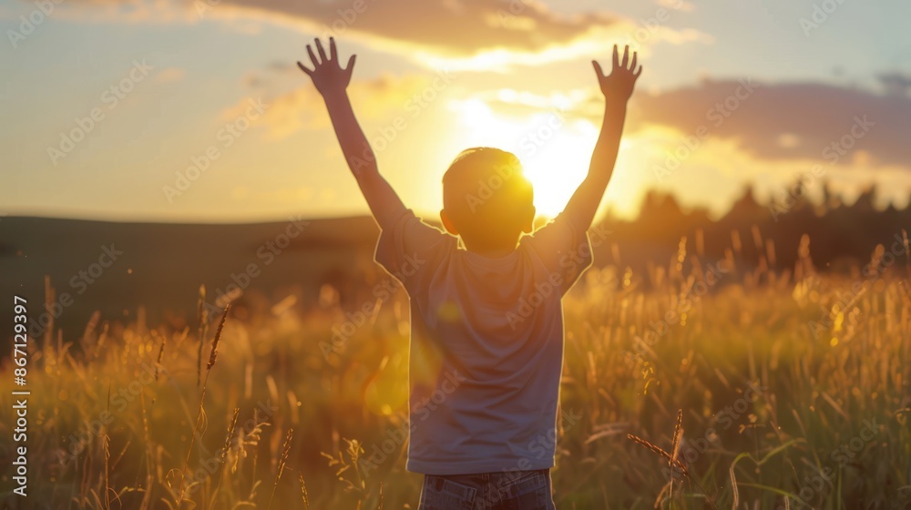 Silhouette of Boy with Arms Raised at Sunset Silhouette of Boy with Arms Raised at Sunset