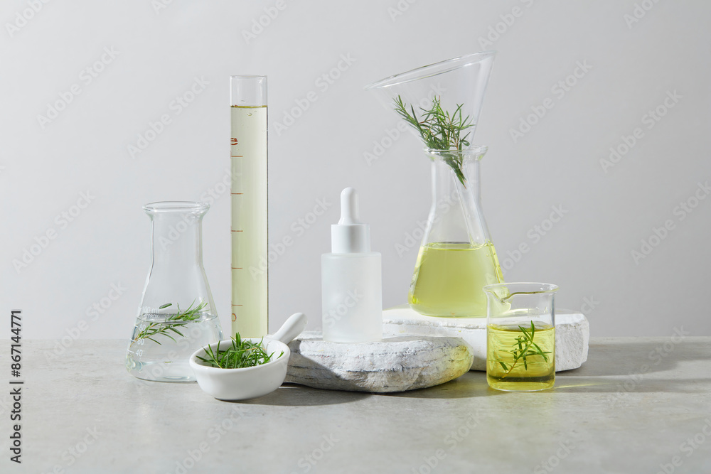 Cosmetic advertising mockup with a blank label white serum bottle placed on a rock pedestal in the center, surrounded by many types of laboratory utensils, over the white texture. Photo of front angle Cosmetic advertising mockup with a blank label white serum bottle placed on a rock pedestal in the center, surrounded by many types of laboratory utensils, over the white texture. Photo of front angle