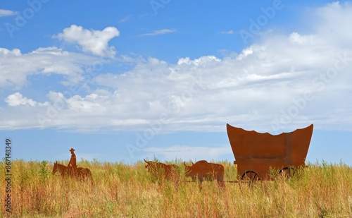 historical marker to the nineteenth century pioneers and wagon trains that  created charlie's ruts  in the prairie off highway 50  along the santa fe trail near lakin, in western kansas