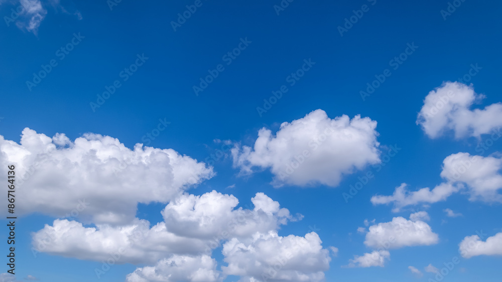 Fototapeta premium clear blue sky background,clouds with background, Blue sky background with tiny clouds. White fluffy clouds in the blue sky.