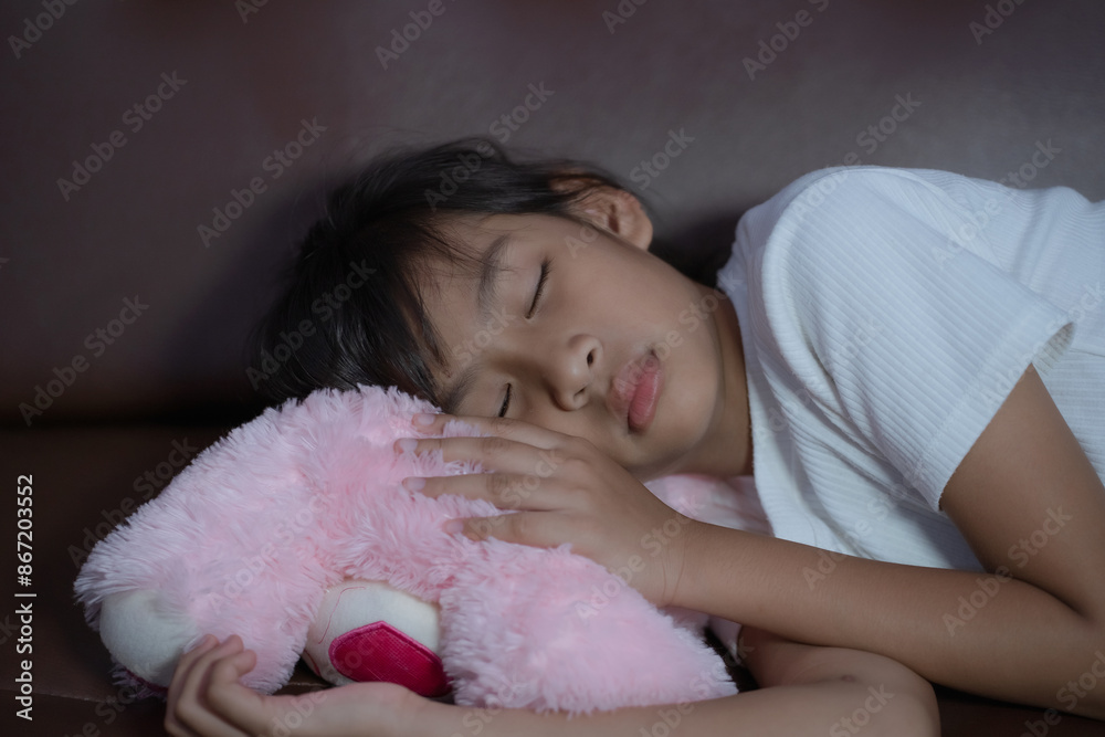 Little girl Asian kid sleeping on cozy sofa at home. Little girl Asian kid sleeping on cozy sofa at home.