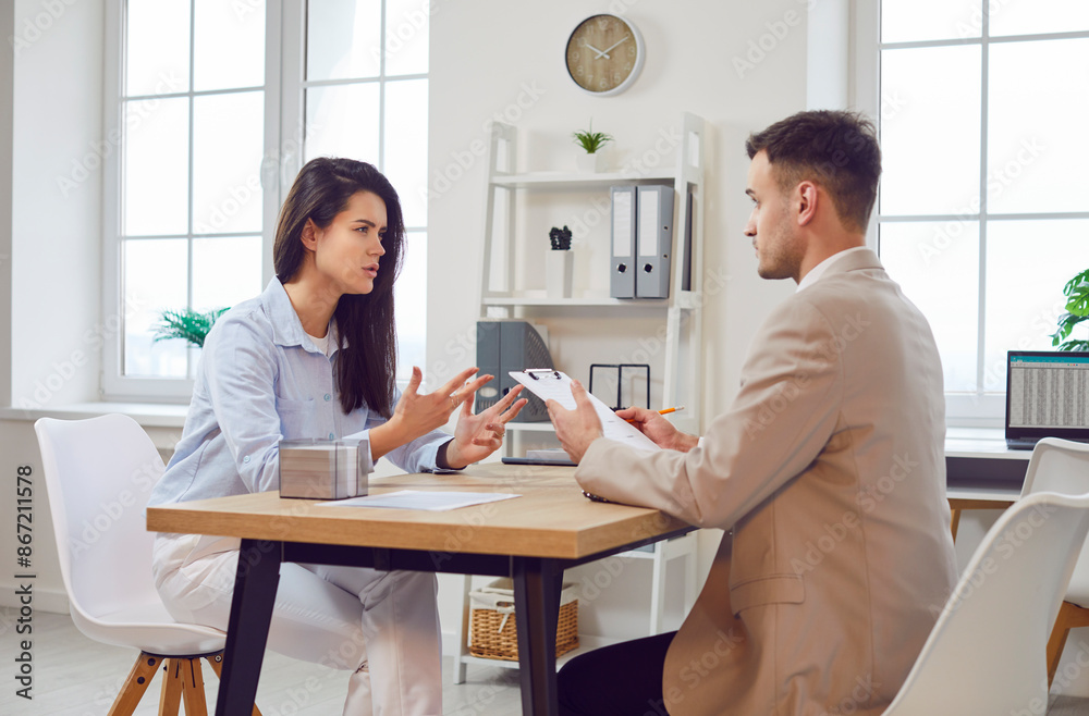 Thoughtful young woman and male business worker working at desk, talking on business interview questions, prepare for meeting, planning budget to discuss finances, startup, individual entrepreneurs Thoughtful young woman and male business worker working at desk, talking on business interview questions, prepare for meeting, planning budget to discuss finances, startup, individual entrepreneurs