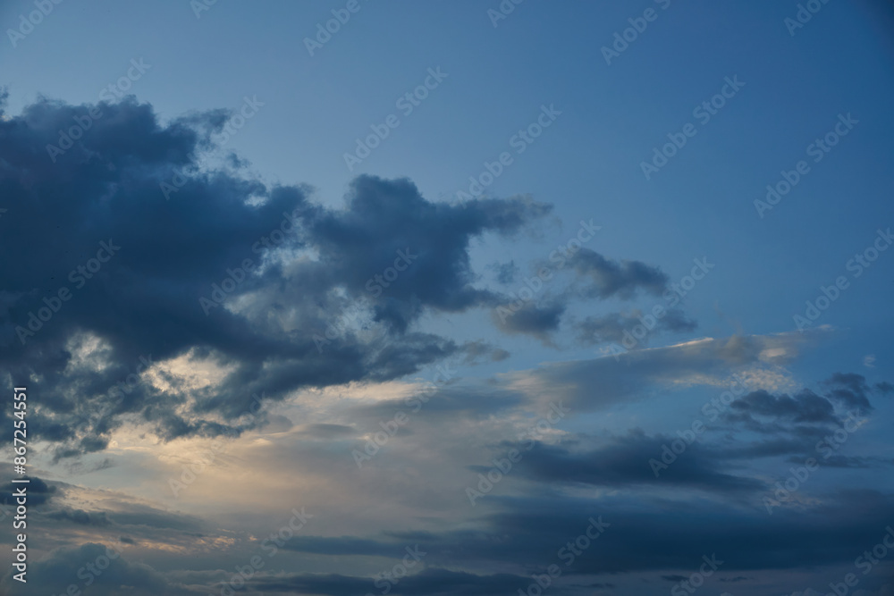 White fluffy clouds in the sky. Blue sky and cloud cover on a sunny summer day. Empty background, copy space White fluffy clouds in the sky. Blue sky and cloud cover on a sunny summer day. Empty background, copy space