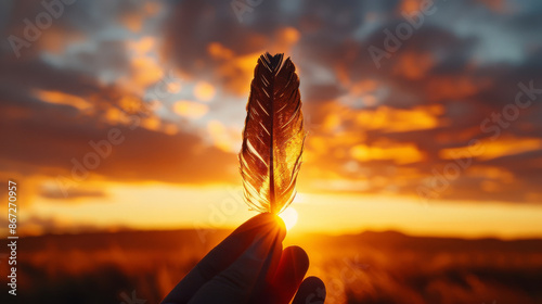 A single weathered feather held in a silhouetted hand transforms into a photorealistic portrait of a majestic bird in flight against a dramatic sunset High Quality High Clarity photo