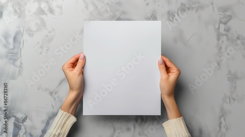 Female hands holding blank magazine gray background design template. Mockup image