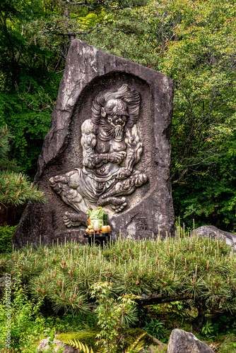 Sculpture in the garden dedicated to Buddhist priest Rocho, who vowed to drive away demons, near Ishiyamadera temple, in Otsu, Shiga Prefecture, Kansai region, Japan.  photo