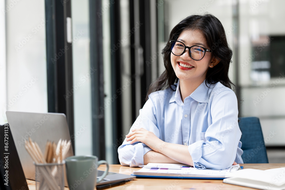 Happy Brunette Business Lady Using Laptop Smiling To Camera Posing Wearing Glasses Working Sitting At Workplace In Modern Office.