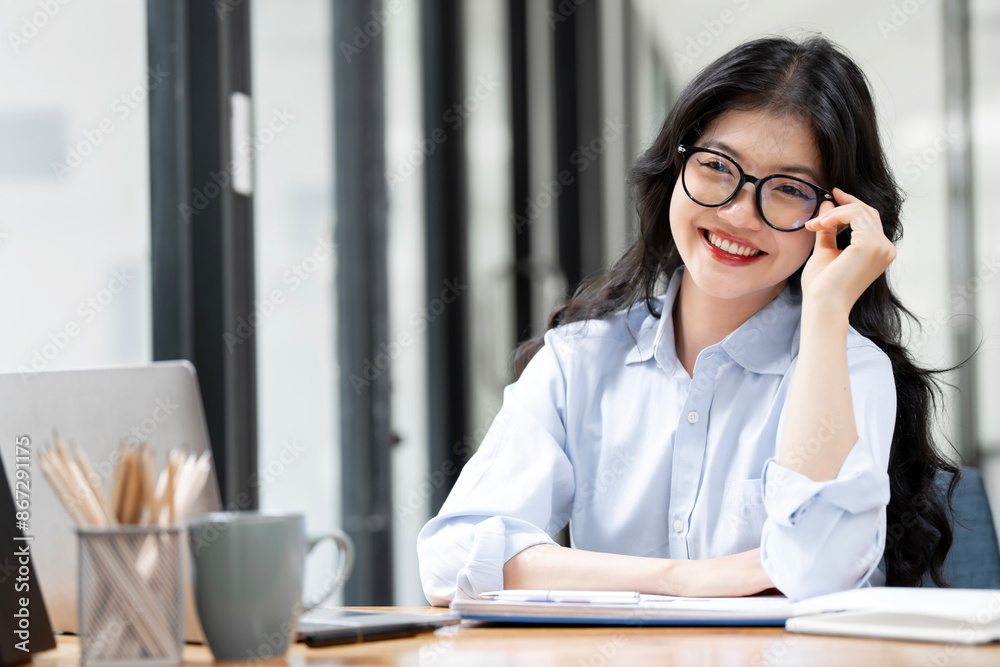 Happy Brunette Business Lady Using Laptop Smiling To Camera Posing Wearing Glasses Working Sitting At Workplace In Modern Office.