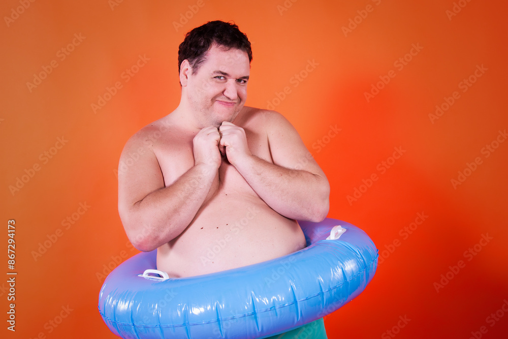 Funny fat man with an inflatable ring. Vacations and holidays. Funny fat man with an inflatable ring. Vacations and holidays.