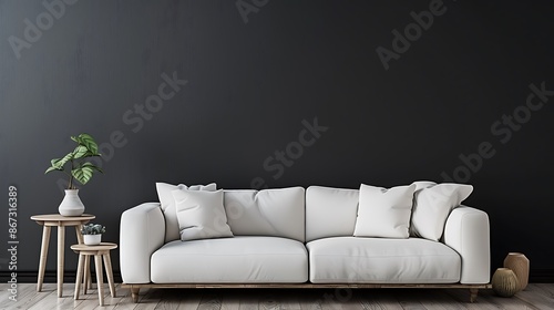 Image of a modern living room with a sofa, side table and plain white pillows on a dark gray wall background. The living room is decorated in a minimalist style. photo